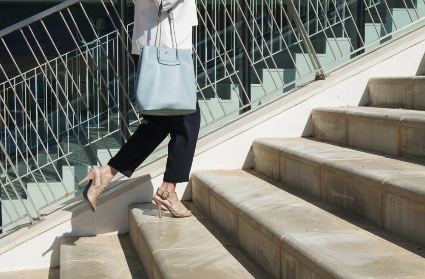 Woman in high heels climbing stairs